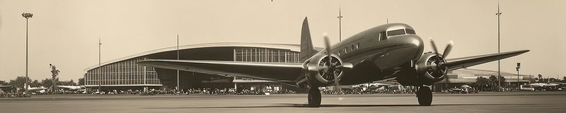 A vintage airplane on the tarmac at an airport.