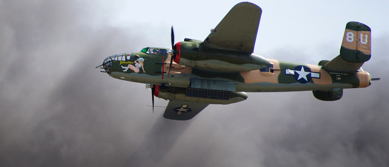 Commemorative Air Force, Central Texas Wing's 1944 B-25J Yellow Rose, San Marcos, TX  Flying  through smoke during the 'Tora Tora Tora' Pearl Harbor Attack Re-enactment - November 1st, 2014